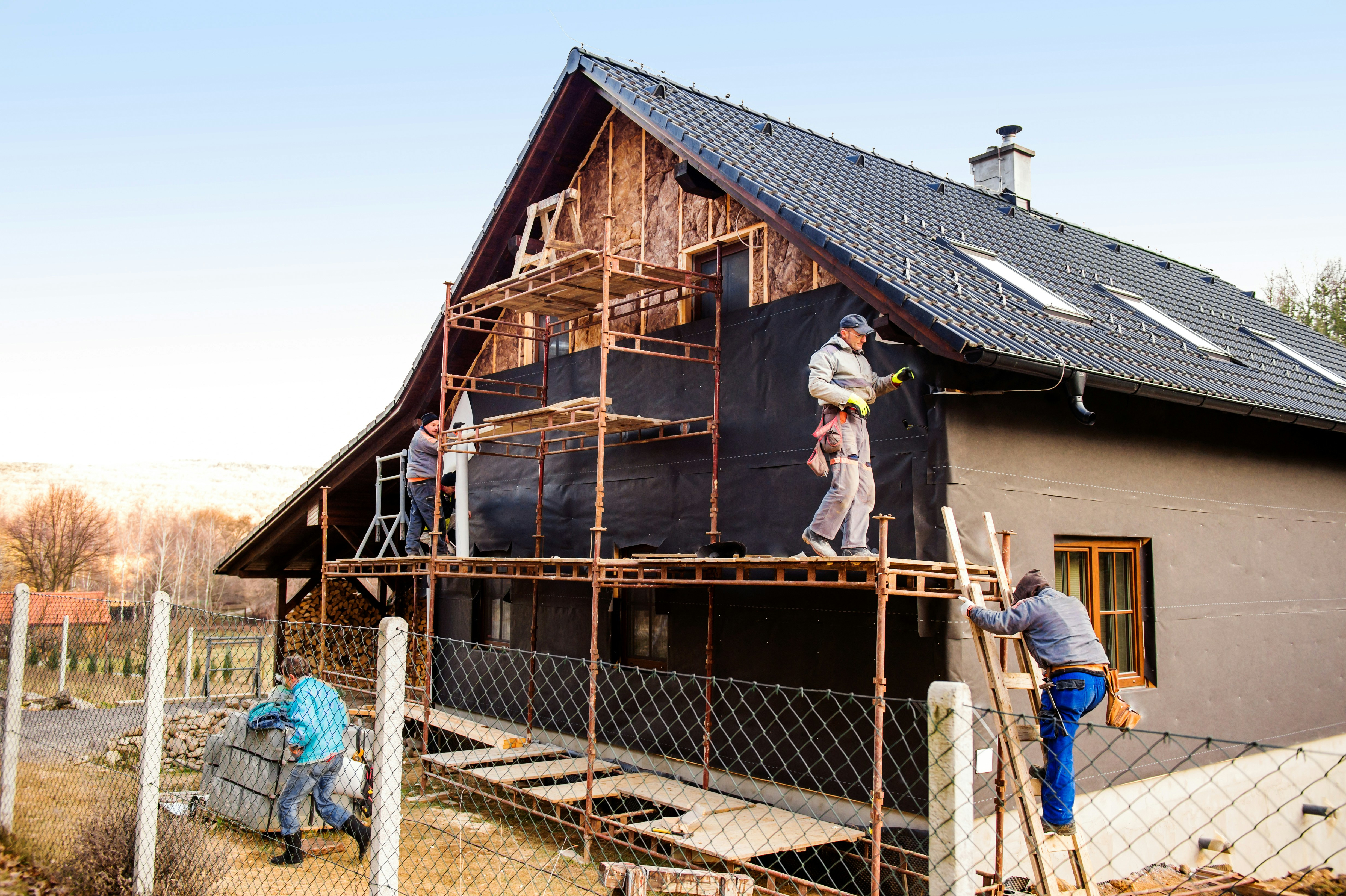 Construction workers standing on a scaffold